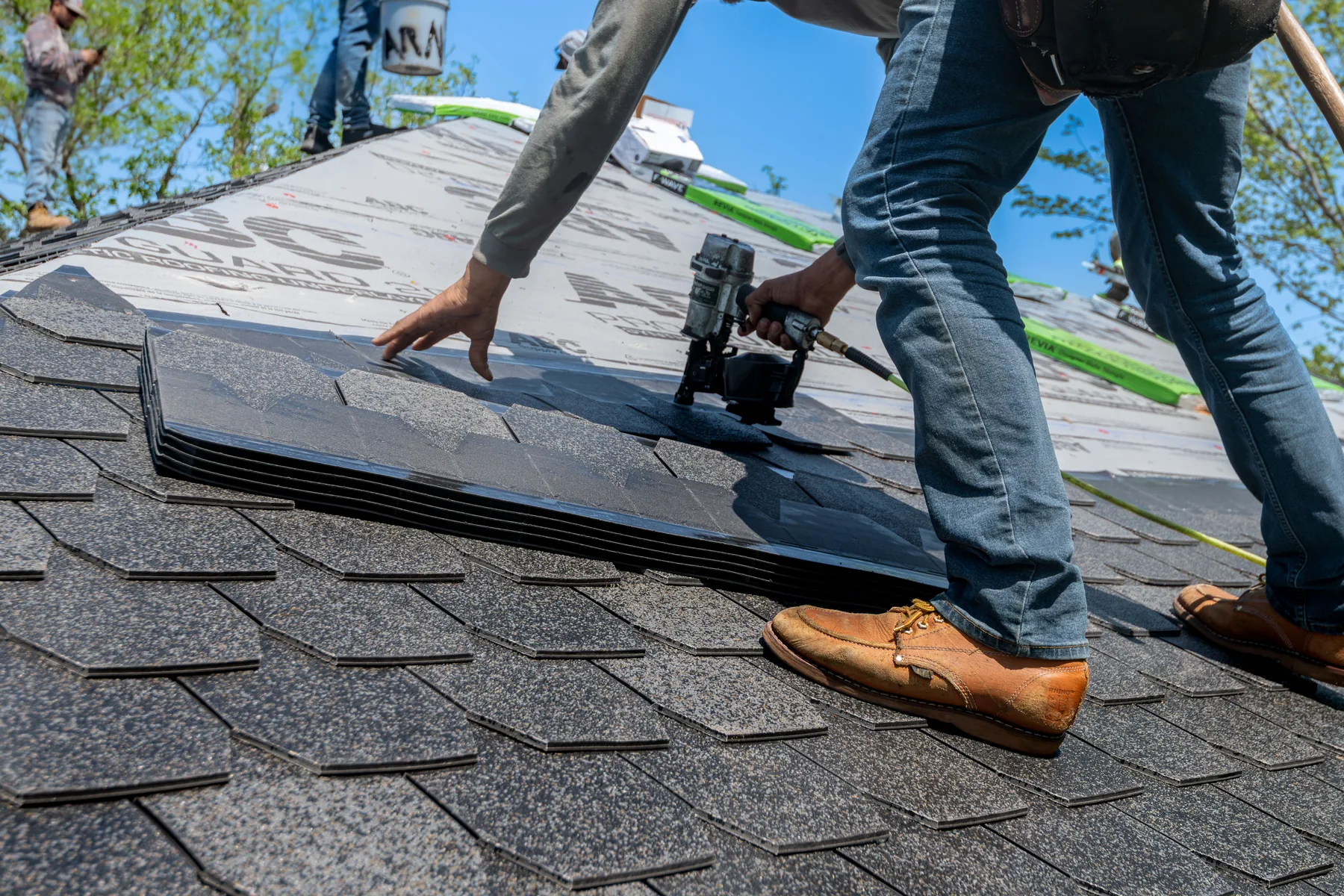 Roofing professional working on a residential home